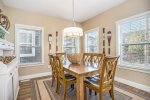 The formal dining room offers comfortable and well-lit seating for 6 guests.